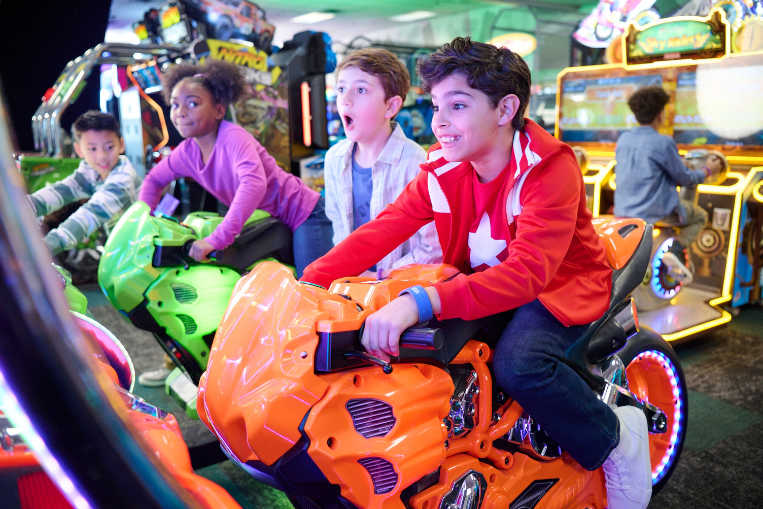 Image of family entertainment centre with kids having fun on arcade games