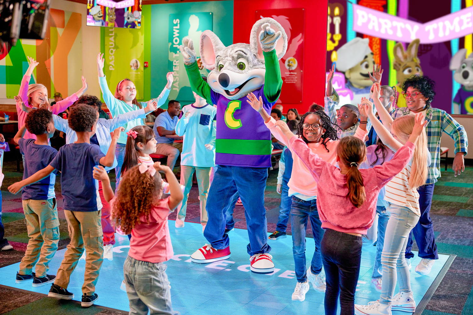 A group of kids with Chuck E. on the interactive dance floor at Chuck E. Cheese