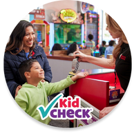 A kid being checked into Chuck E. Cheese for a group event