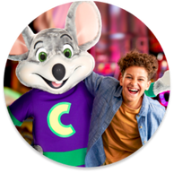 A kid with Chuck E. at a Chuck E. Cheese team building group event