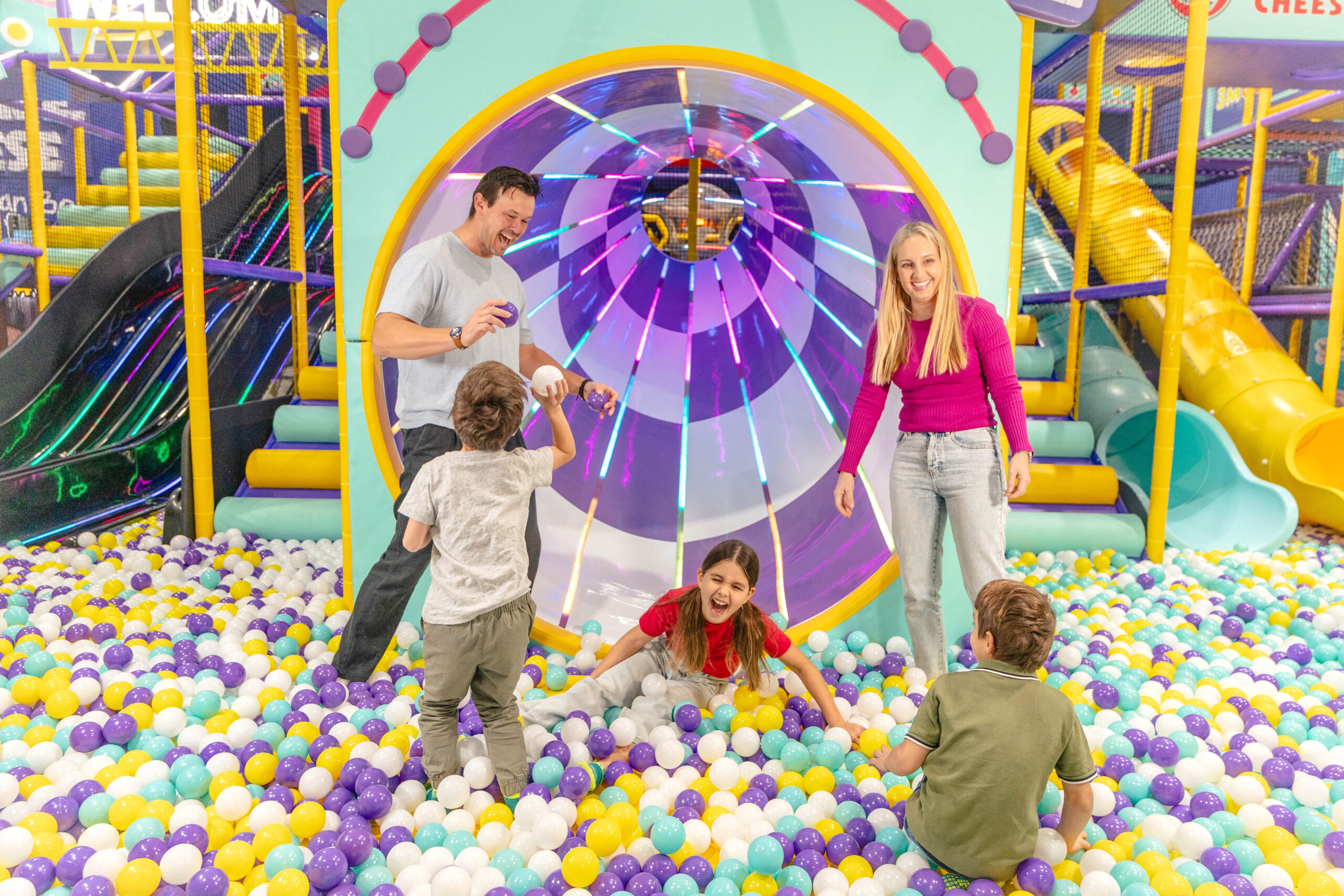 A photo of a family playing in the ball pit at Chuck E. Cheese Joondalup's indoor playground