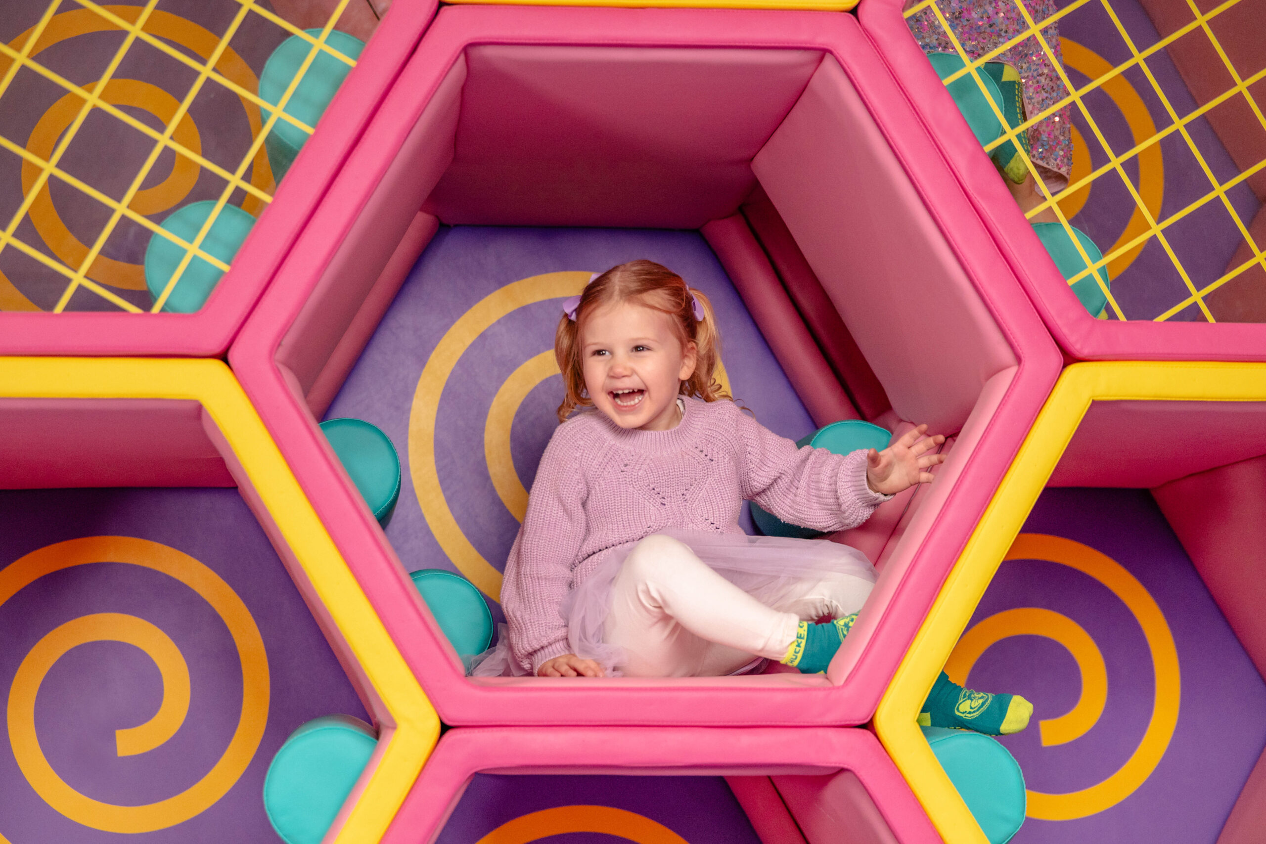 A photo of a toddler exploring the Toddler Zone at Chuck E. Cheese.