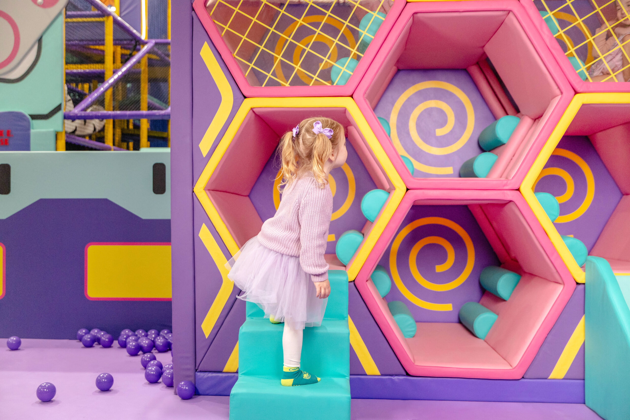 A photo of a toddler in the sensory soft play structures of the toddler zone indoor playground at chuck E. Cheese Joondalup.