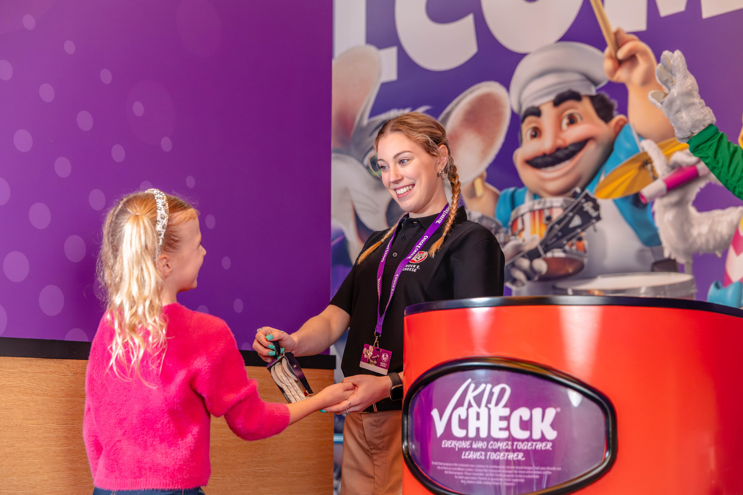 A photo of a kid going through Kid-Check at Chuck E. Cheese before entering the indoor playground.
